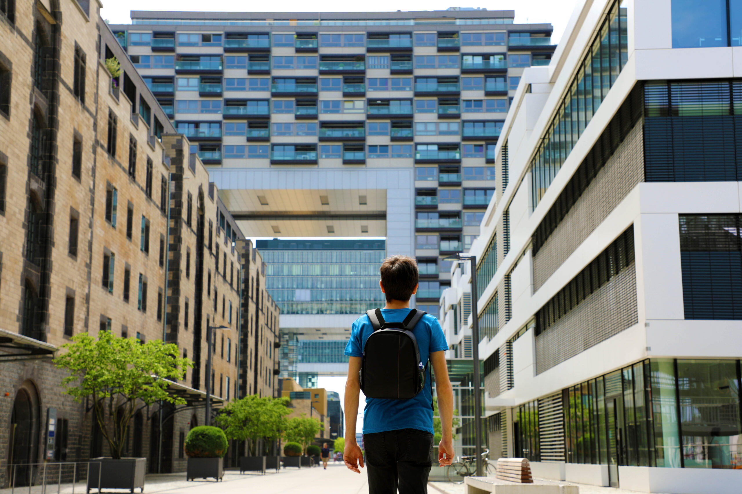 Tempe Student Housing Rear view of a young man with backpack just arrived in big city